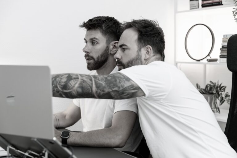 Floreal Rubio Serrano und Jan Becker am Schreibtisch.